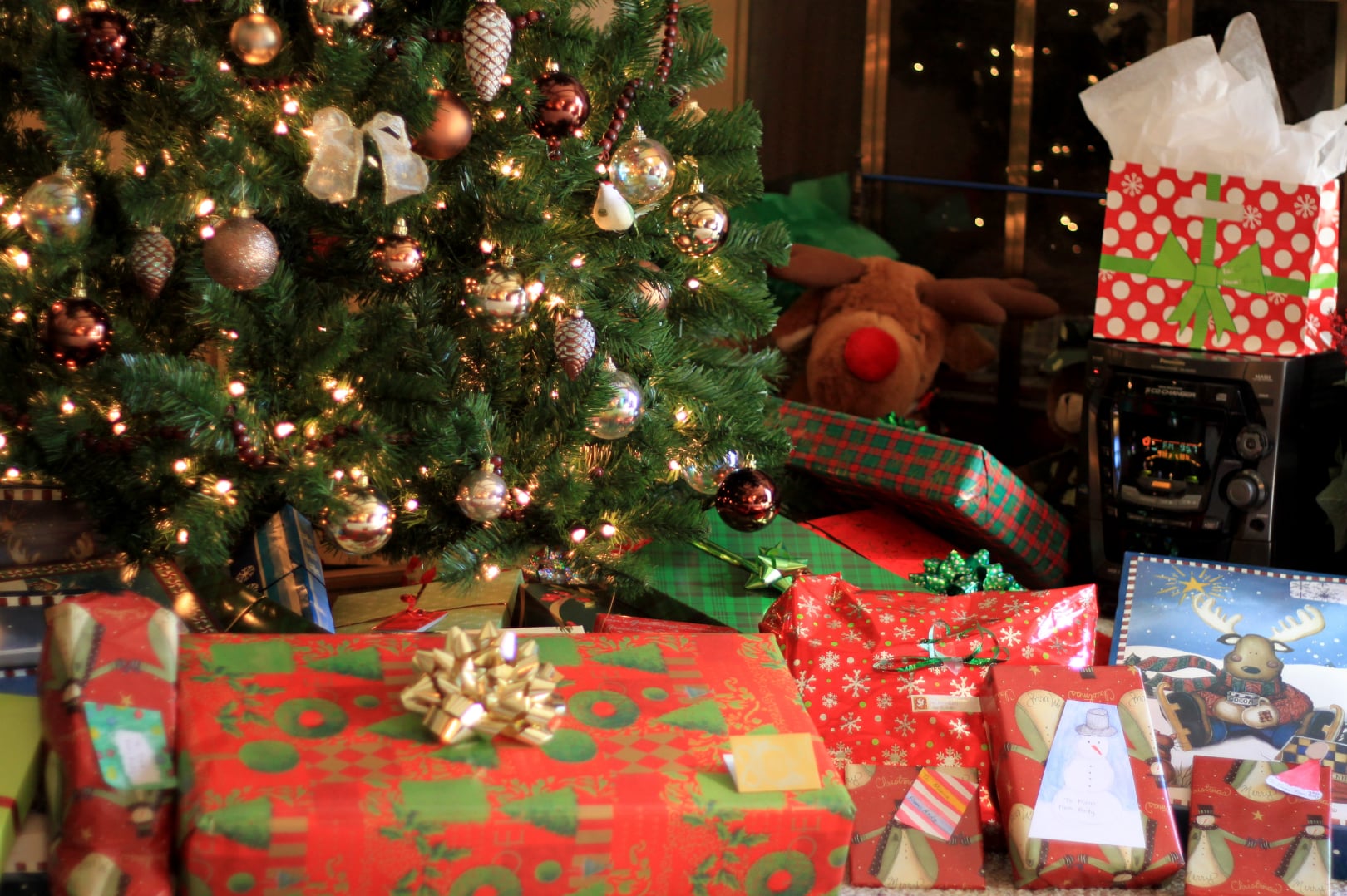 Christmas gifts wrapped in colorful paper under and Christmas tree